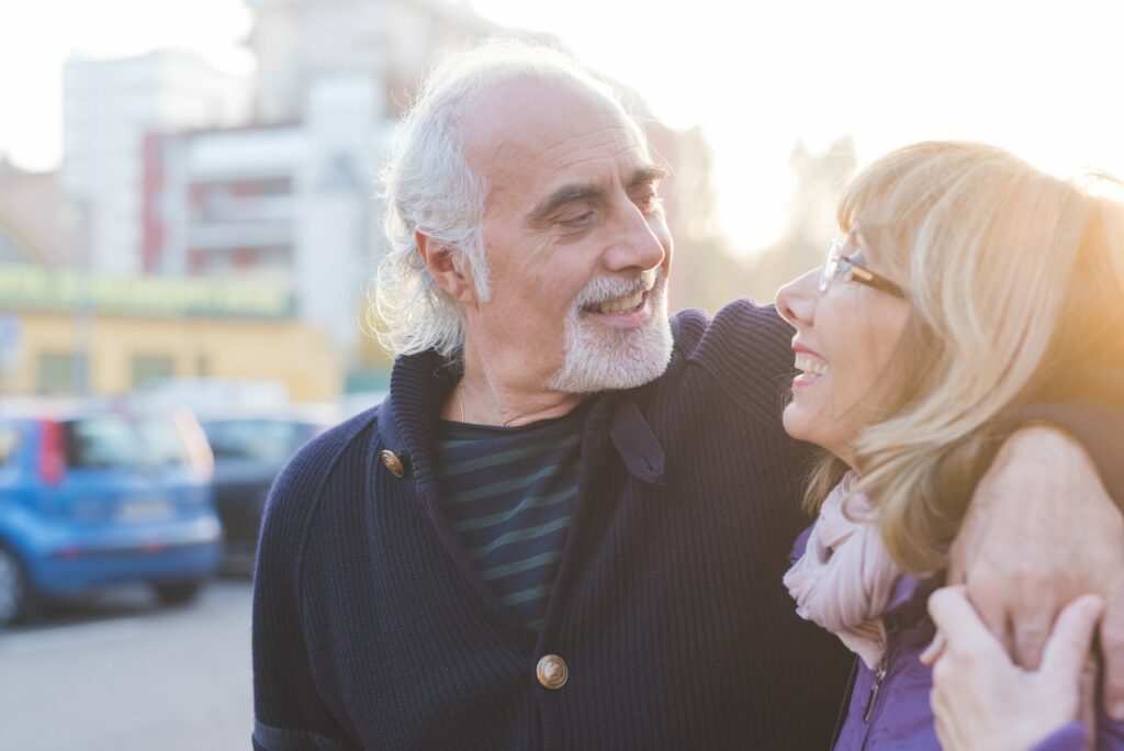 Middle age couple hugging outdoor backlight