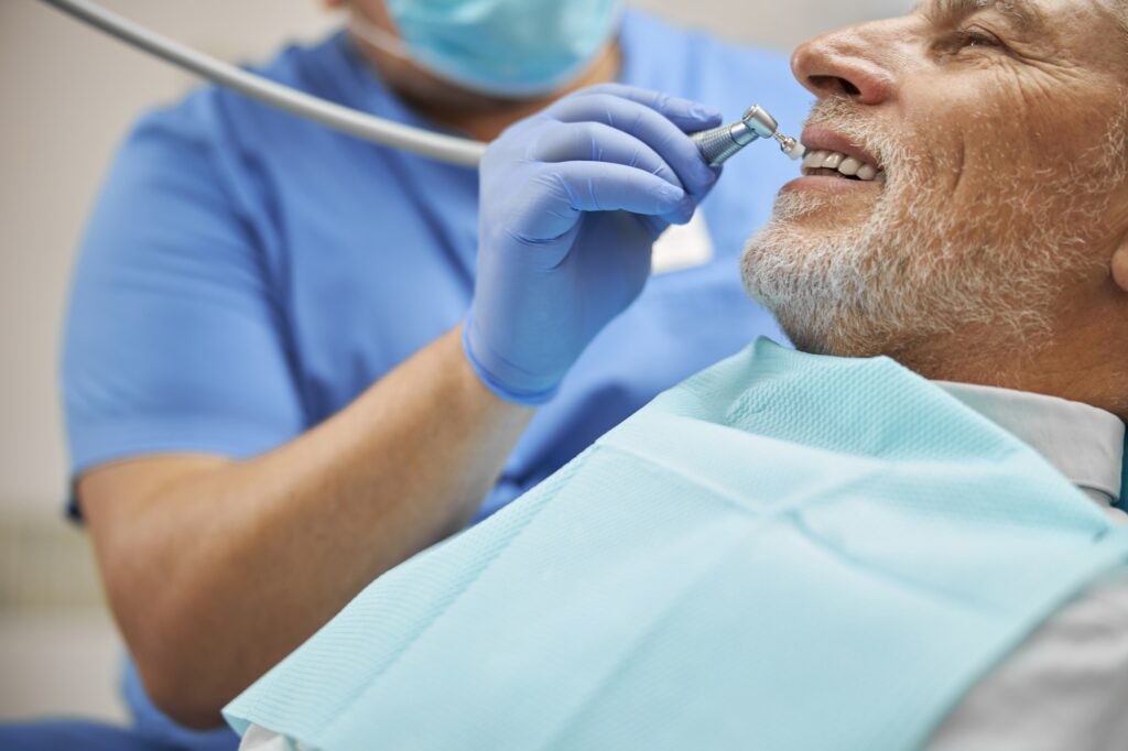 Qualified dentist working with a dental burnisher