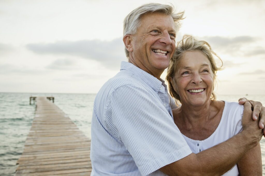 Spain, Senior couple embracing at the sea